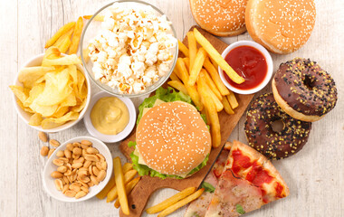 assorted of american food,  fast food mix (burger, popcorn, french fries, donut, pizza)