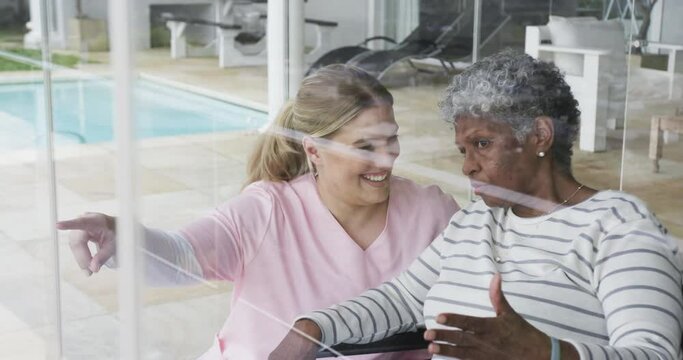 Smiling caucasian nurse with senior woman patient with copy space, slow motion