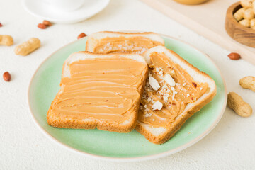 Peanut butter sandwiches or toasts on light table background.Breakfast. Vegetarian food. American cuisine top view vith copy space
