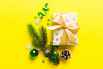 Top view Flat lay Christmas decorations and gift box on colored background with copy space....