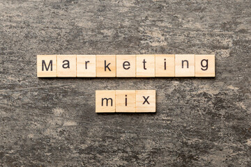 MARKETING MIX word written on wood block. MARKETING MIX text on cement table for your desing, concept