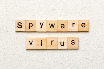 Spyware virus word written on wood block. Spyware virus text on cement table for your desing, concept