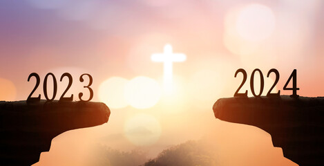 New Year 2024 and 2023 on on the mountain at sunset with  white cross background