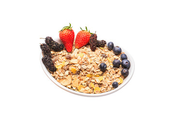 Top view of delicious breakfast bowl of corn flakes with strawberries, blueberries and mulberry