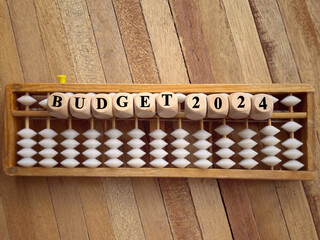 New Year financial plan concept. Budget 2024 written on wooden blocks. With blurred styled background.