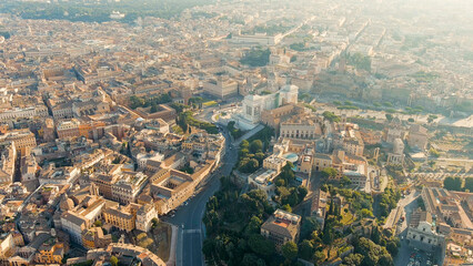 Rome, Italy. Vittoriano - Monument to the first king of Italy, Victor Emmanuel II. Flight over the city. Panorama of the city in the morning. Backlight. Summer, Aerial View