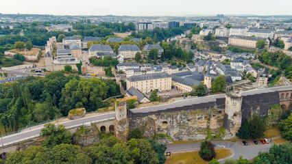 Fototapeta na wymiar Luxembourg City, Luxembourg. Bock Casemates. Panoramic view of the historical part of Luxembourg city. The city is located in a deep valley of two rivers - Alzette and Petrus, Aerial View