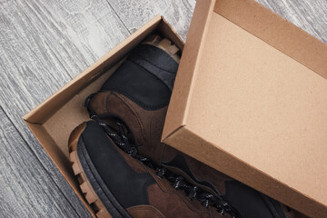 Open the box with a pair of new shoes. Closeup view on the purchased footwear in paper package. - 664794703