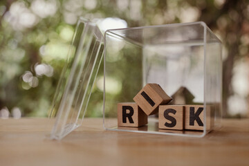 Wooden cubes with risk words in the box. Risk management and eliminating the risk