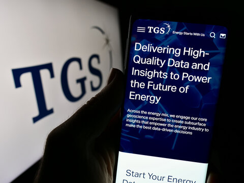 Stuttgart, Germany - 09-28-2023: Person holding cellphone with webpage of analytics business TGS-NOPEC Geophysical Company ASA in front of logo. Focus on center of phone display.
