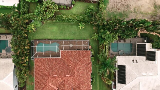 Aerial Above wide view of screened in pool and lanai in florida house. Top down shot