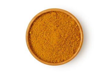 Curry powder in wooden bowl on white background