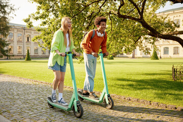 Happy company of students using electric scooter vehicles