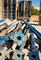 The supports of monolithic floor formwork at a construction site. Telescopic props for concrete flooring. Construction of a modern apartment building