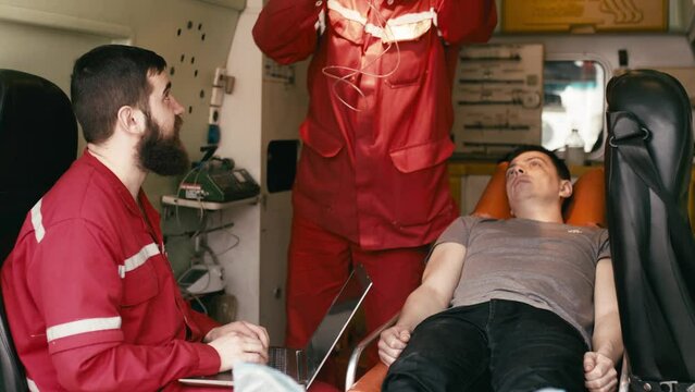 Patient, paramedic and blood pressure with oxygen mask in ambulance for emergency, trauma or medical care. First aid, human and anesthesia for medical health.