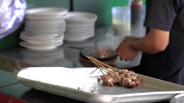Grilled lamb skewers being prepared by the cook. Shot in 4k resolution.