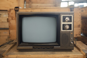 An old TV sits on a box. Retro technology concept. 