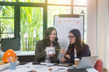 Architectural woman designer making digital building plan for professional construction renovation in office.