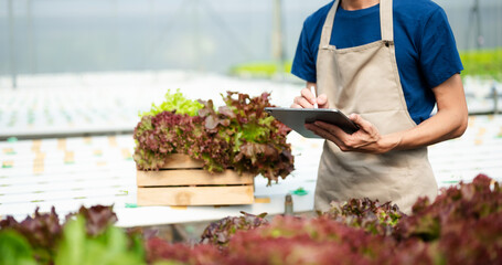 Smart farmer using application by tablet concepts modern agricultural technology and visual icon screen .Smart farming .