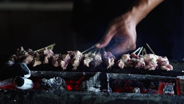 Grilling meat or lamb skewers. Indonesian traditional food. Tasty dish. Shot in 4k resolution. Slo-mo.