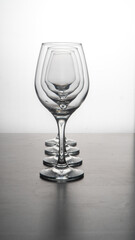 Glass wine glasses in reverse light. Crystal wine glasses with water drops