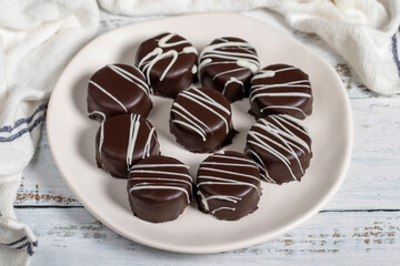 Chocolate cookie. Delicious cookies with coconut inside and chocolate outside on a wooden background. patisserie products