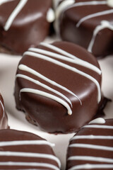 Chocolate cookie. Delicious cookies with coconut inside and chocolate outside on a wooden background. patisserie products. Close up