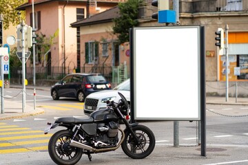 Billboard on the street next to a motorcycle in Lugano.