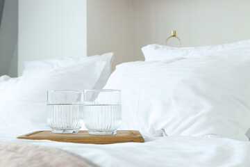 Glasses of water on a wooden board