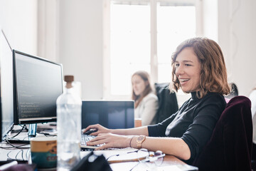 Women in startup business and entrepreneurship. Yound devoted female AI programmers and IT software...