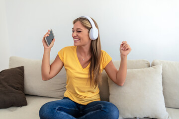 Headphones, phone and sofa woman or student with meme video, internet chat and music for mental...