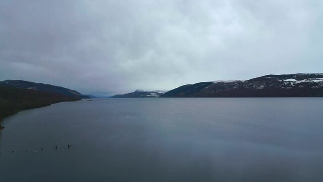 Snow capped hills line both sides of the famous lake Loch Ness