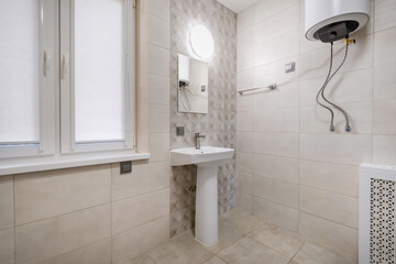 toilet and detail of a corner shower cabin with wall mount shower attachment