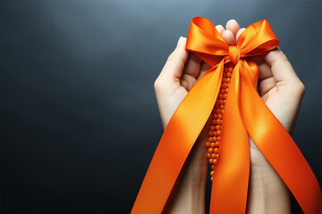 orange ribbon in woman's hand