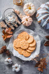 Chai latte cookies or ginger biscuits with pumpkins and candles for autumn season