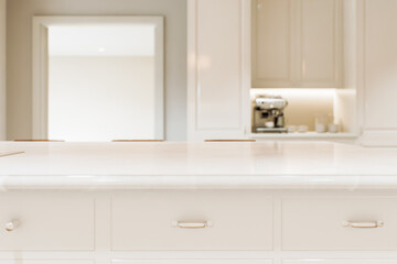 Fototapeta na wymiar Kitchen white countertop with white marble, with blurred bokeh background. 