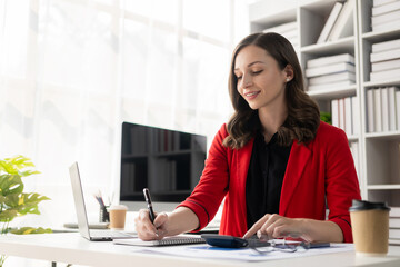 Businesswoman or accountant working with graph documents and charts to analyze market data, balance sheets, company accounts and net sales profits.
