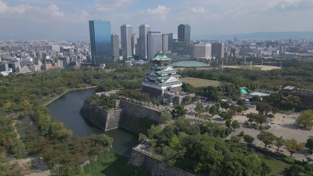 flying towards Osaka Castle with Osaka skyline in background