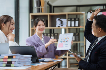 Businessmen team or financial data analysts working with tablets and laptop computers and data graphs together. Plan to analyzing projects in the office.