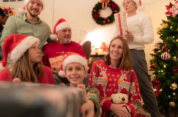Fototapeta na wymiar Merry Christmas and Happy Holidays! Cheerful family celebrating Christmas at home.