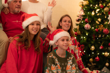 Merry Christmas and Happy Holidays! Cheerful family celebrating Christmas at home.