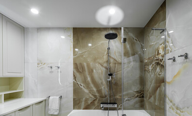 Bright bathroom with stone tiles on the walls. Modern bathroom interior.