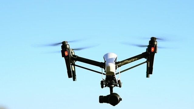 Drone, technology and flight on blue sky for photography surveillance or filming nature and background. Remote control, videography and futuristic robot device or machine for aerial recording