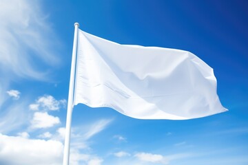 a white flag waving against blue sky