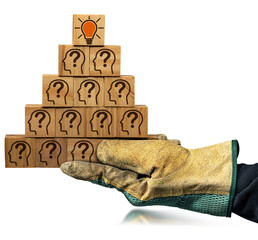 Creative idea and innovation concept. Gloved hand holding a stack of wooden blocks with symbols with human heads and question marks and a light bulb on the top. Isolated on white or transparent, png.