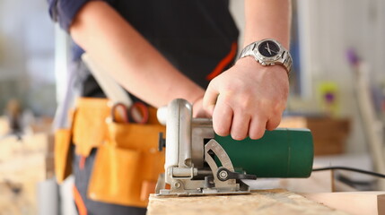 Arms of worker using electric saw closeup. Manual job workplace DIY inspiration improvement fix shop yellow helmet hard hat joinery startup idea industrial education profession career concept