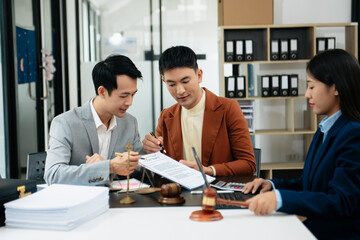 Business and lawyers discussing contract papers with brass scale on desk in office. Law, legal services, advice,  justice and law concept ..