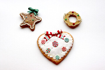photo of Christmas cookies in the shape of a heart, star and wreath on a white background, close-up