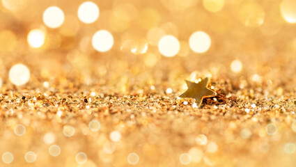 Golden star on Christmas particles for a holiday celebration, Christmas and new year. Shiny golden lights background.