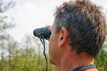 Man watching with binoculars